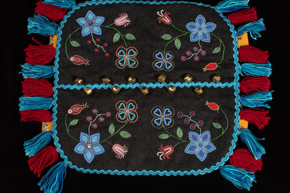 Melton cloth, canvas backing, bells, seed beads, wool yarn artwork by Yukon artist Anne Tayler. Part of the Yukon Permanent Art Collection